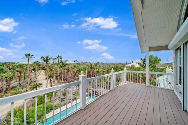 deck featuring an outdoor pool