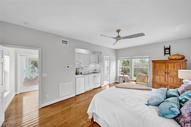 bedroom featuring baseboards, a ceiling fan, visible vents, and light wood-style floors