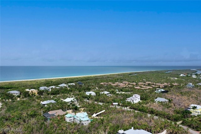 birds eye view of property featuring a water view and a view of the beach