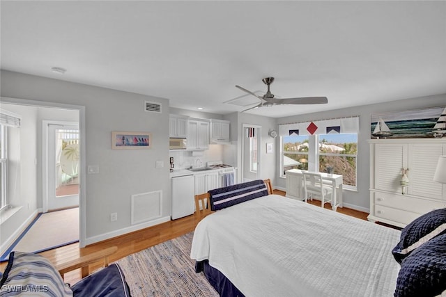 bedroom featuring a ceiling fan, baseboards, visible vents, and light wood finished floors