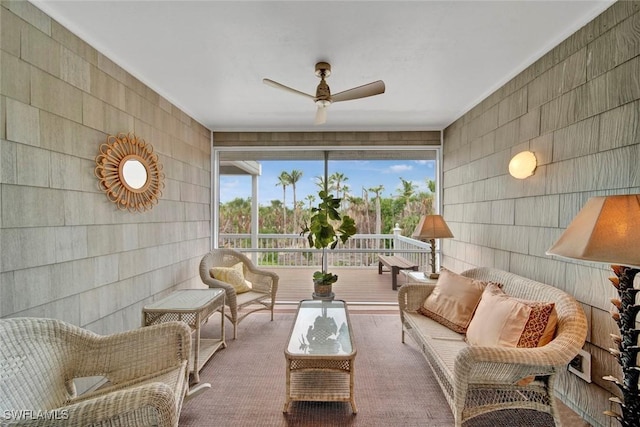 sunroom / solarium featuring a ceiling fan