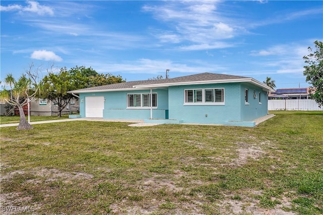 view of front of house featuring a garage, fence, and a front lawn