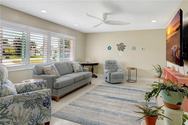 living room featuring recessed lighting, a ceiling fan, and baseboards