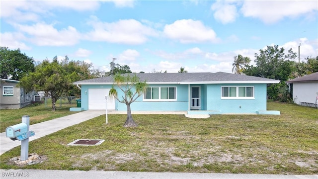 ranch-style home with a garage, concrete driveway, fence, a front yard, and brick siding