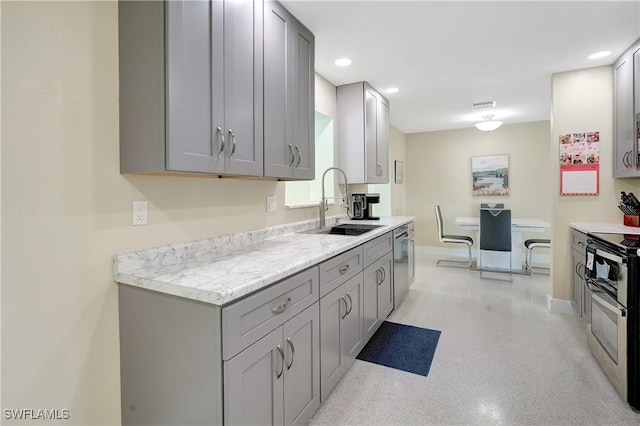 kitchen featuring stainless steel appliances, gray cabinets, light countertops, visible vents, and a sink