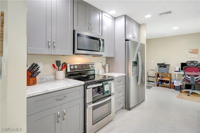 kitchen with recessed lighting, stainless steel appliances, visible vents, gray cabinets, and light stone countertops