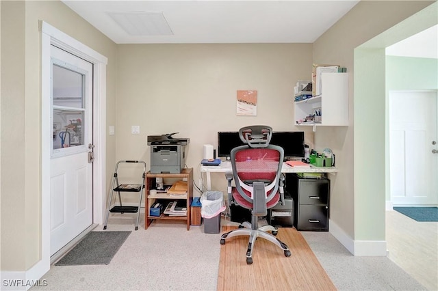 carpeted home office with baseboards