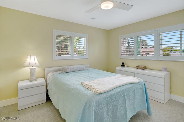 bedroom with ceiling fan and baseboards