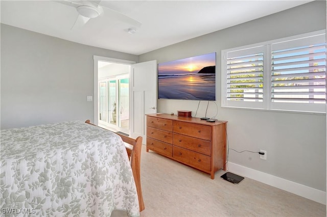 bedroom with baseboards, a ceiling fan, and light colored carpet