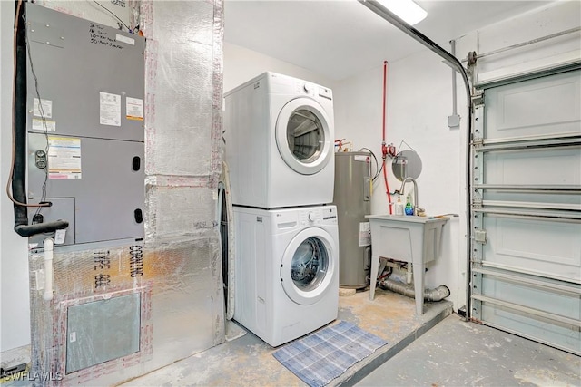 washroom with a garage, stacked washing maching and dryer, water heater, and laundry area