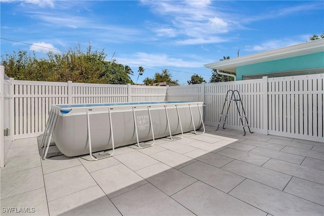 view of patio featuring a fenced backyard and a fenced in pool