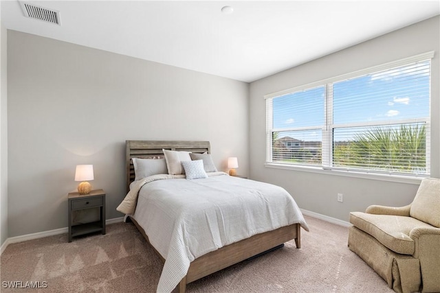 bedroom featuring visible vents, baseboards, and carpet floors