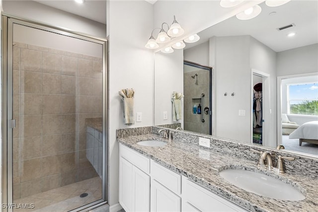 full bathroom featuring double vanity, visible vents, a stall shower, and a sink