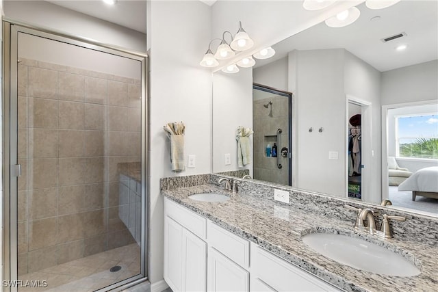 bathroom featuring a shower stall and double vanity