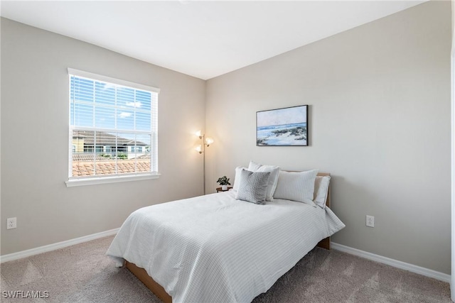 carpeted bedroom featuring baseboards