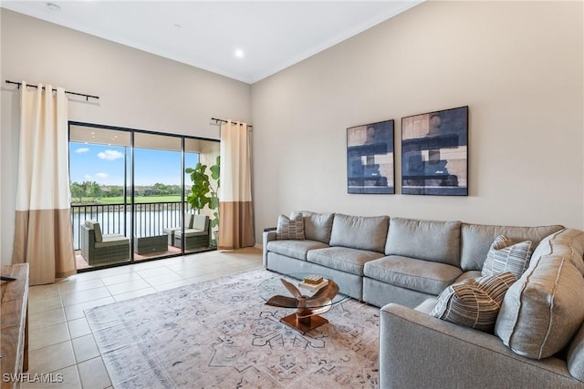 9365 Pocida Ct Unit 203, Naples, FL 34119 - living area with light tile patterned flooring, a towering ceiling, and a water view