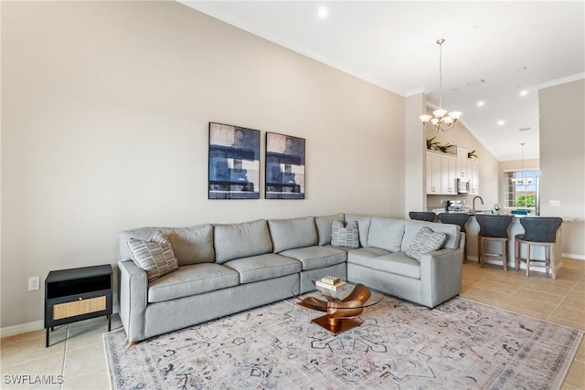 9365 Pocida Ct Unit 203, Naples, FL 34119 - living room featuring a chandelier, light tile patterned floors, ornamental molding, baseboards, and vaulted ceiling