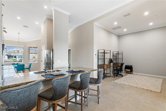 dining space featuring visible vents, crown molding, light tile patterned floors, baseboards, and a chandelier