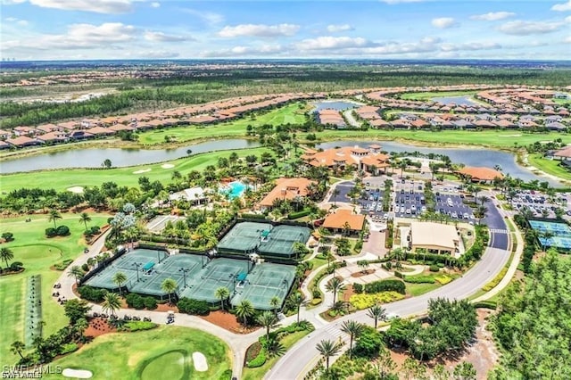 drone / aerial view featuring a residential view, a water view, and view of golf course