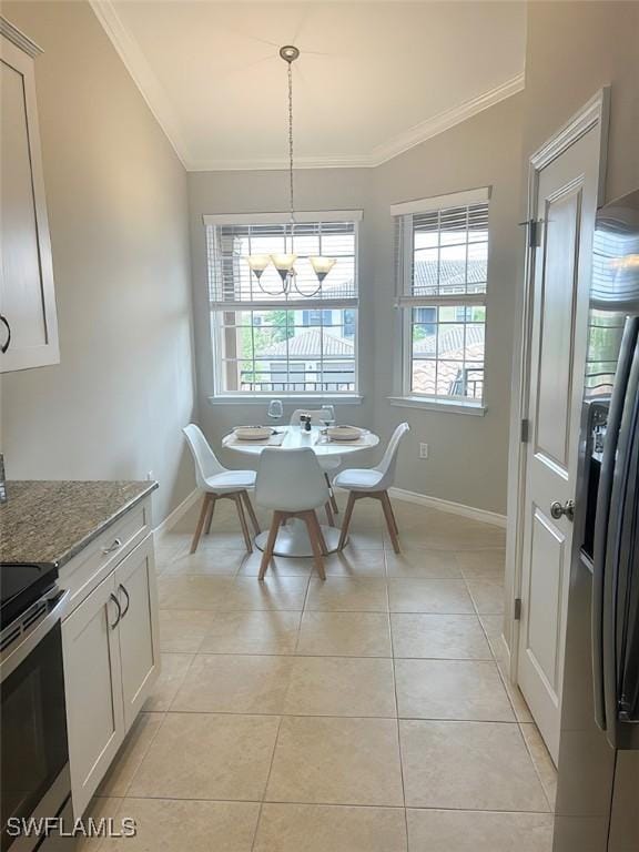 9365 Pocida Ct Unit 203, Naples, FL 34119 - dining space with ornamental molding, a chandelier, baseboards, and light tile patterned floors