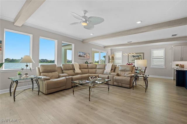 living area featuring a water view, plenty of natural light, light wood-type flooring, and beam ceiling