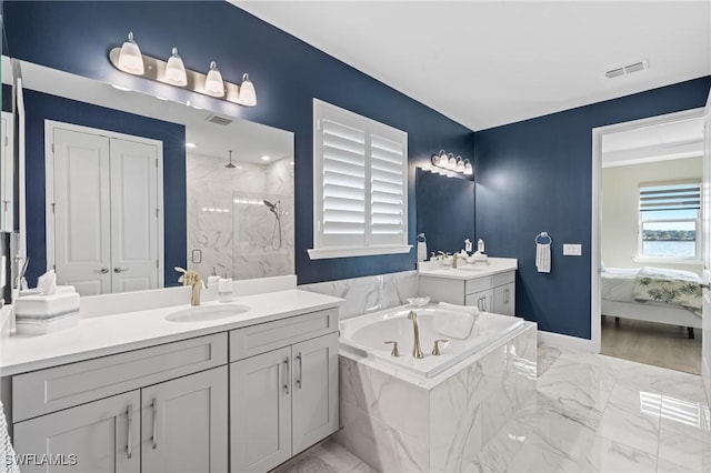 ensuite bathroom with marble finish floor, visible vents, a sink, and a marble finish shower