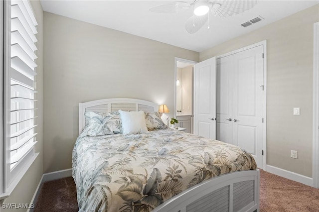 bedroom featuring dark colored carpet, a closet, visible vents, and baseboards