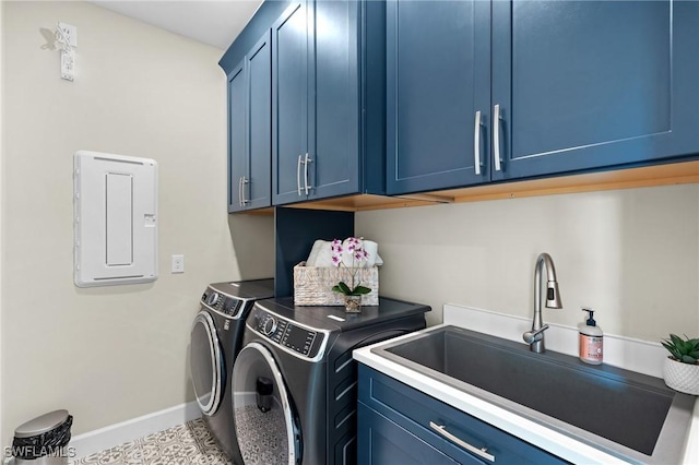 laundry room featuring cabinet space, a sink, separate washer and dryer, electric panel, and baseboards