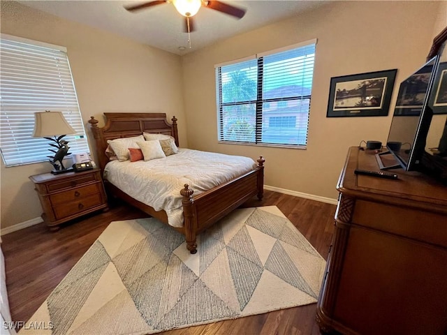 bedroom featuring ceiling fan, baseboards, and dark wood-style flooring