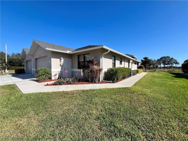 view of property exterior featuring a garage, concrete driveway, a lawn, and stucco siding