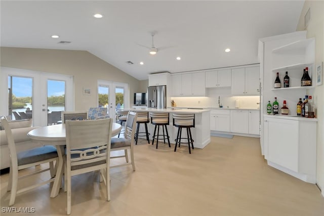 dining room with french doors, recessed lighting, visible vents, a ceiling fan, and vaulted ceiling