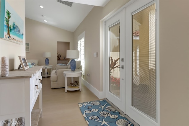 interior space featuring lofted ceiling, recessed lighting, visible vents, light wood-style floors, and baseboards