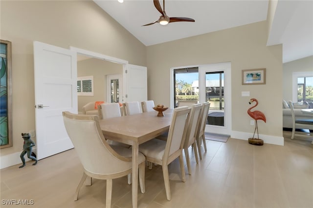 dining room featuring a ceiling fan, high vaulted ceiling, and baseboards