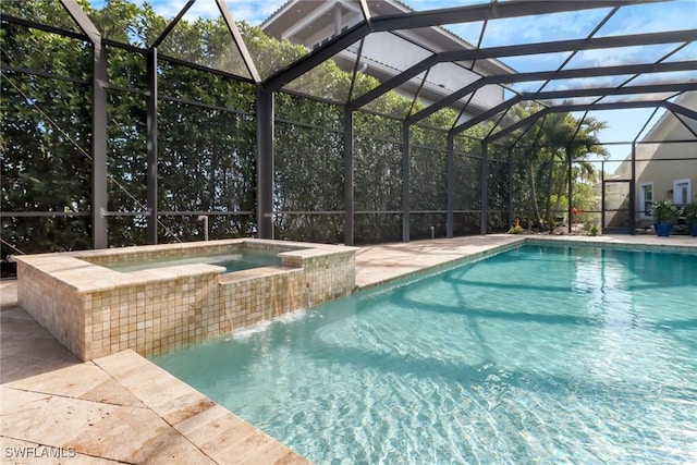 pool with a lanai, a patio area, and an in ground hot tub