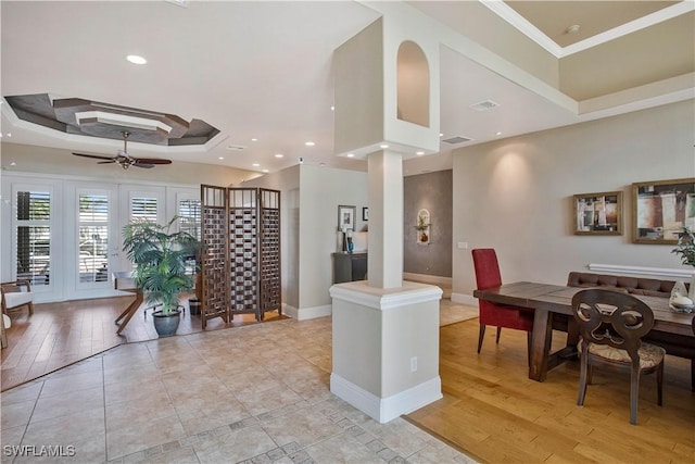 interior space with ceiling fan, visible vents, and decorative columns