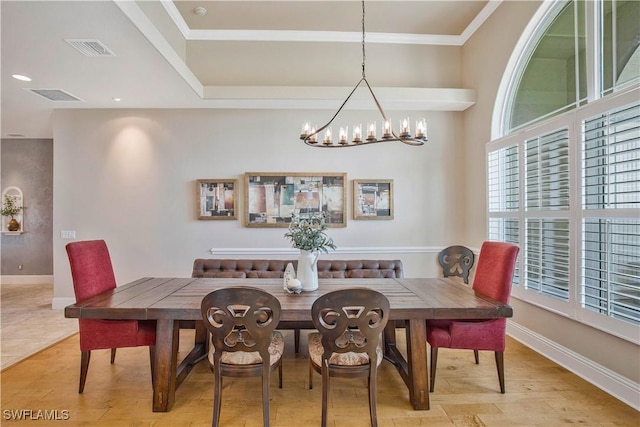 dining space featuring light wood-style floors, visible vents, and baseboards