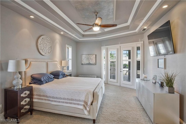 bedroom with light colored carpet, access to exterior, french doors, a raised ceiling, and crown molding