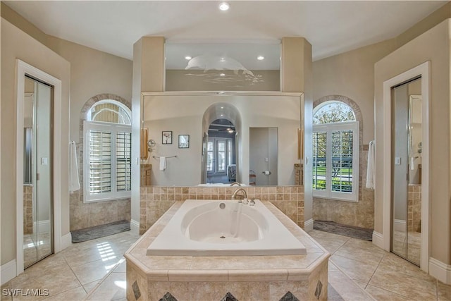 full bath with tile patterned floors, walk in shower, and a bath