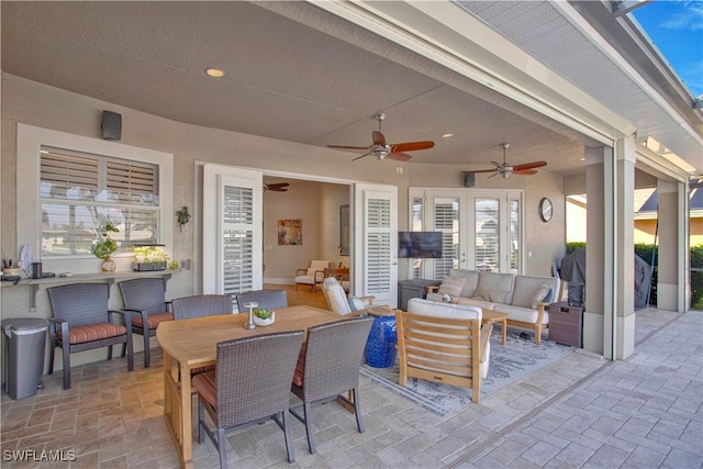 view of patio / terrace featuring ceiling fan, an outdoor living space, french doors, and outdoor dining space