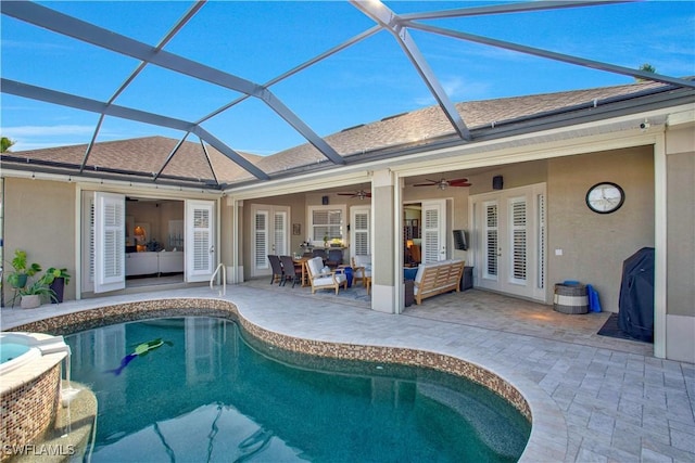 view of swimming pool featuring ceiling fan, a patio, a lanai, an outdoor hangout area, and a pool with connected hot tub