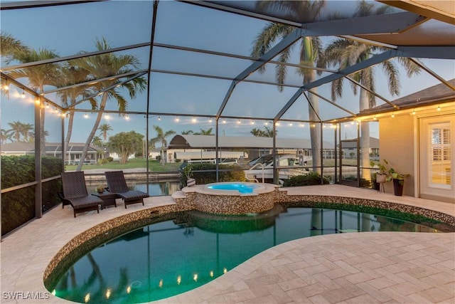 view of pool with glass enclosure, a pool with connected hot tub, and a patio