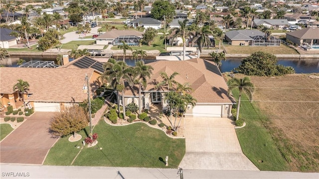 drone / aerial view featuring a water view and a residential view