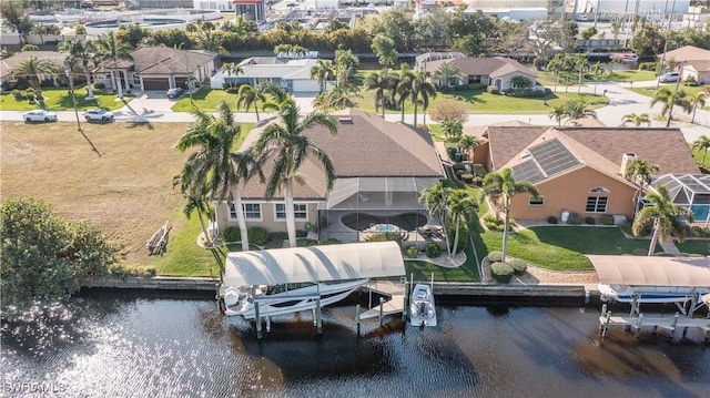 bird's eye view featuring a water view and a residential view