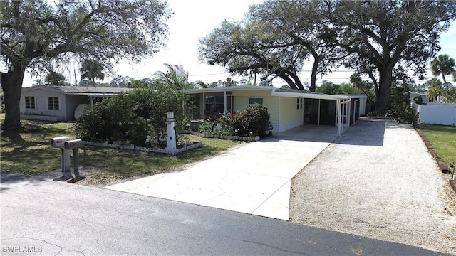 view of front of house with driveway and a carport