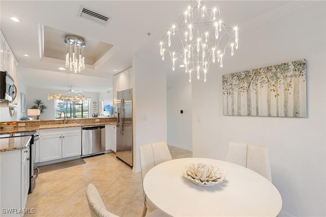 dining space featuring visible vents, an inviting chandelier, a tray ceiling, light tile patterned flooring, and recessed lighting