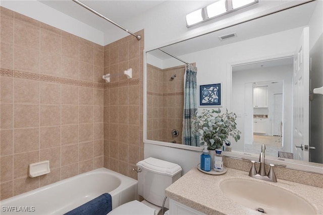 full bathroom featuring toilet, vanity, shower / bath combination with curtain, and visible vents