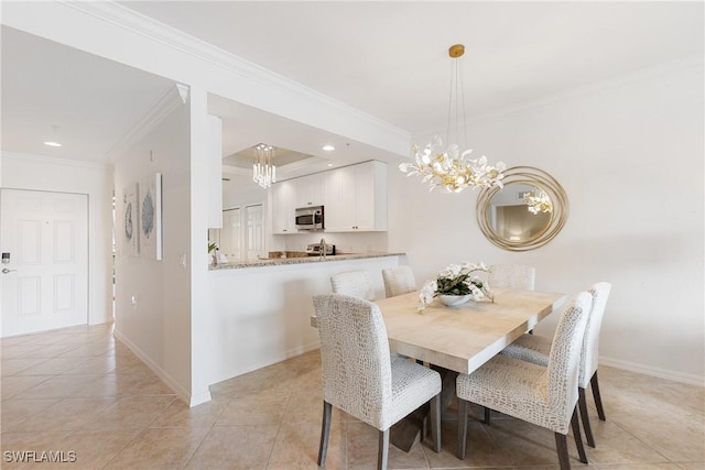 dining room featuring a chandelier, ornamental molding, baseboards, and light tile patterned floors