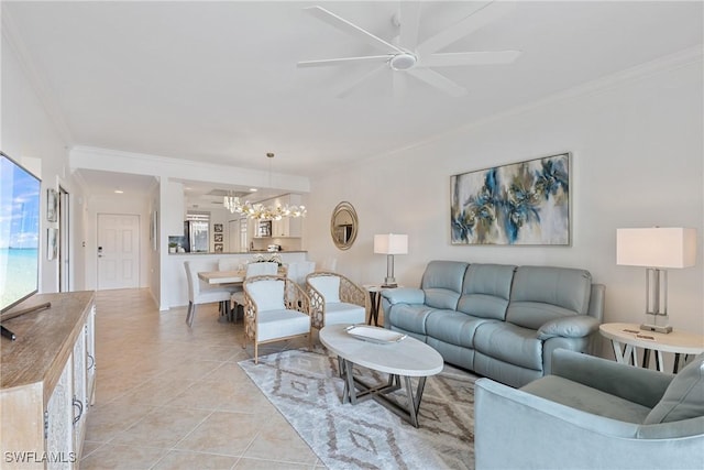 living room featuring light tile patterned floors, ornamental molding, and ceiling fan with notable chandelier