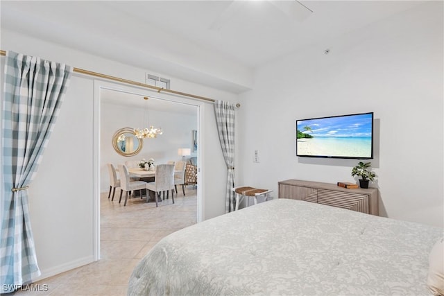 bedroom featuring light tile patterned floors, visible vents, and ceiling fan with notable chandelier