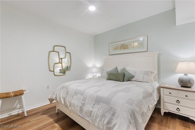 bedroom with wood finished floors, a ceiling fan, and baseboards